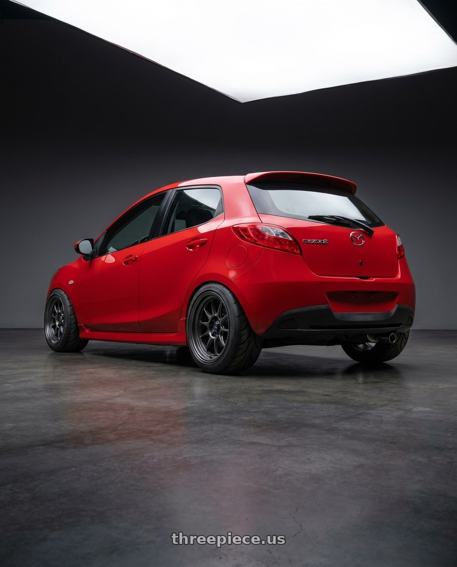 2011 Mazda Mazda2 GT, Red with Konig MRK1 4X100 17x8+40 Hyper Carbon - Gloss Black Gear Cap/Logo/Cover Plate wheels rear three quarter view meaty tires