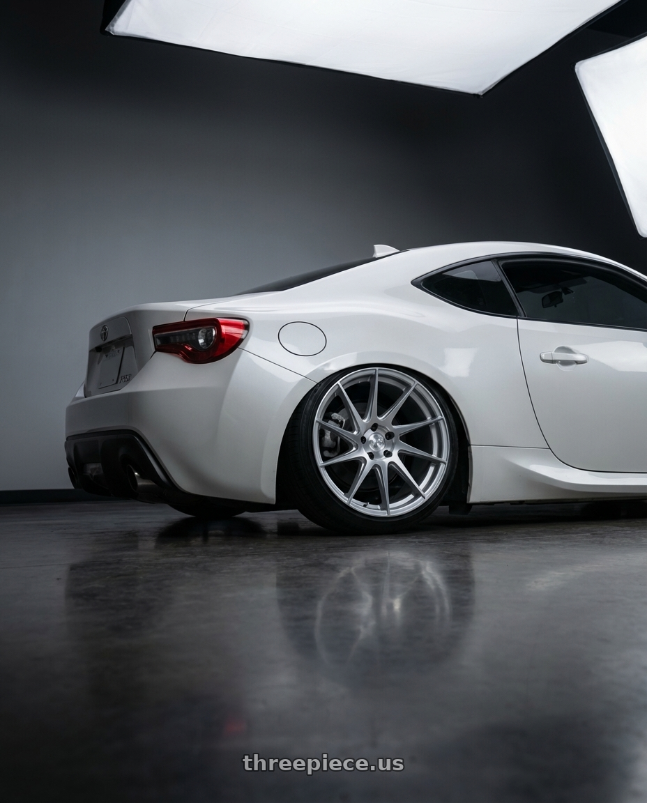 2016 Scion FR-S with Aodhan AH09 5x100 18x8.5 +35 Gloss Silver Machined Face wheels rear three quarter view slight stretch tires