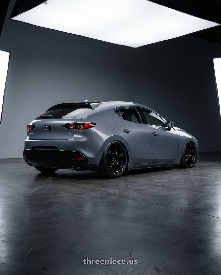 2023 Mazda Mazda3 Turbo with Gram Lights 57CR 5x114.3 18x8.5+37 Glossy Black wheels rear three quarter view slight stretch tires