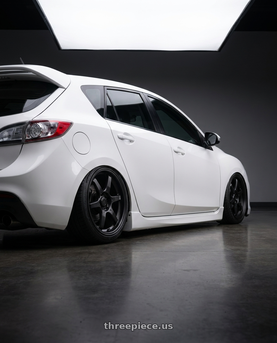 2012 Mazda Mazdaspeed3 with Konig Backbone 5x114.3 18x8+35 Matte Black Milling Logo on Spoke wheels rear three quarter view slight stretch tires