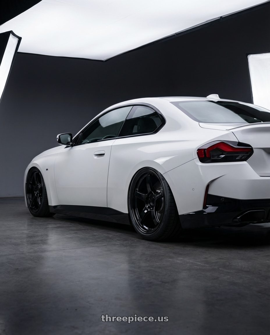 2024 BMW 2 Series G42 with Gram Lights 57CR 5x112 19x9.5+25 Glossy Black wheels rear three quarter view slight stretch tires