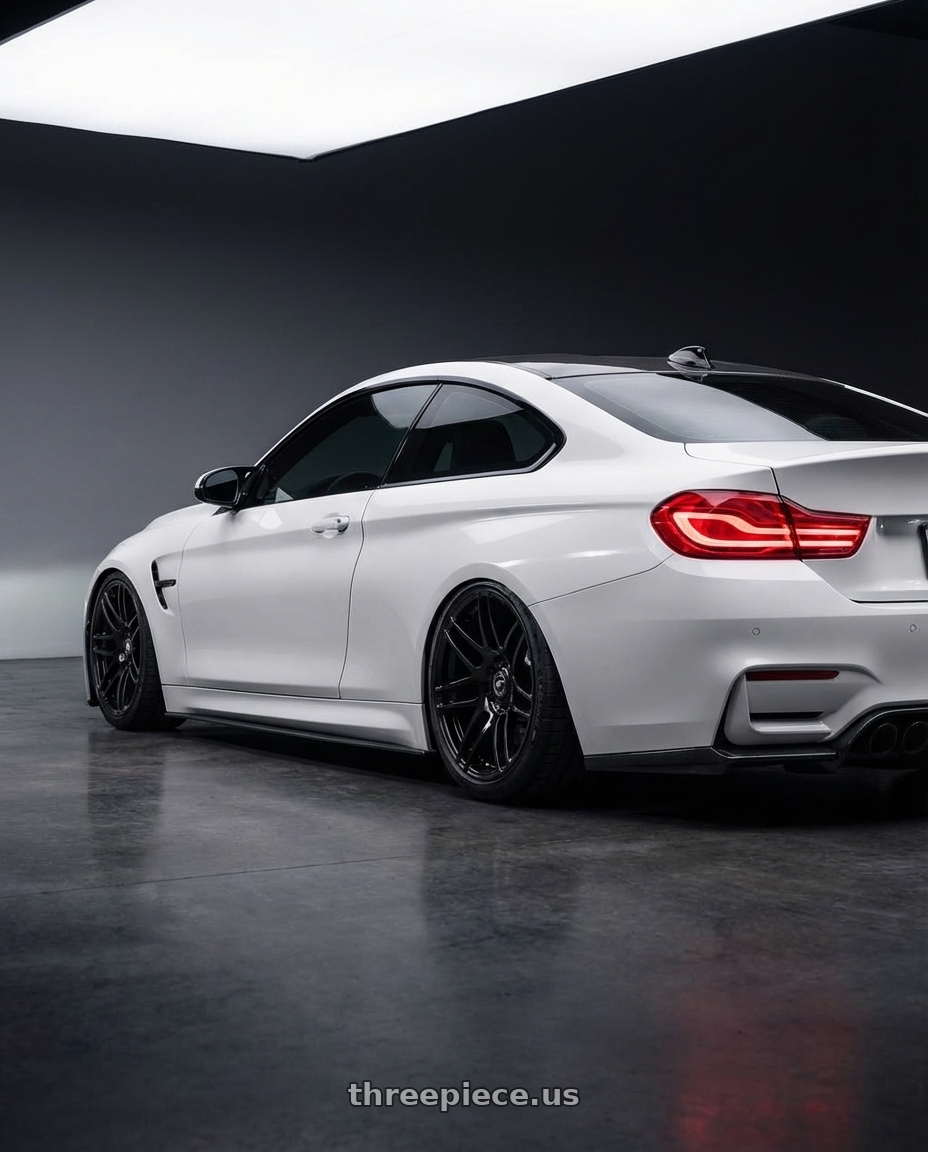 2018 BMW M4 F82 with Forgestar F14 5x120 19x9 +38 Gloss Black wheels rear three quarter view slight stretch tires