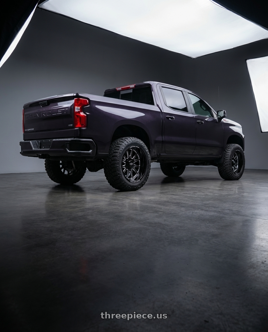 2023 Chevrolet Silverado 1500 with Moto Metal MO401 6X139.7 20X10 -24 GLOSS BLACK MILLED wheels rear three quarter view meaty tires
