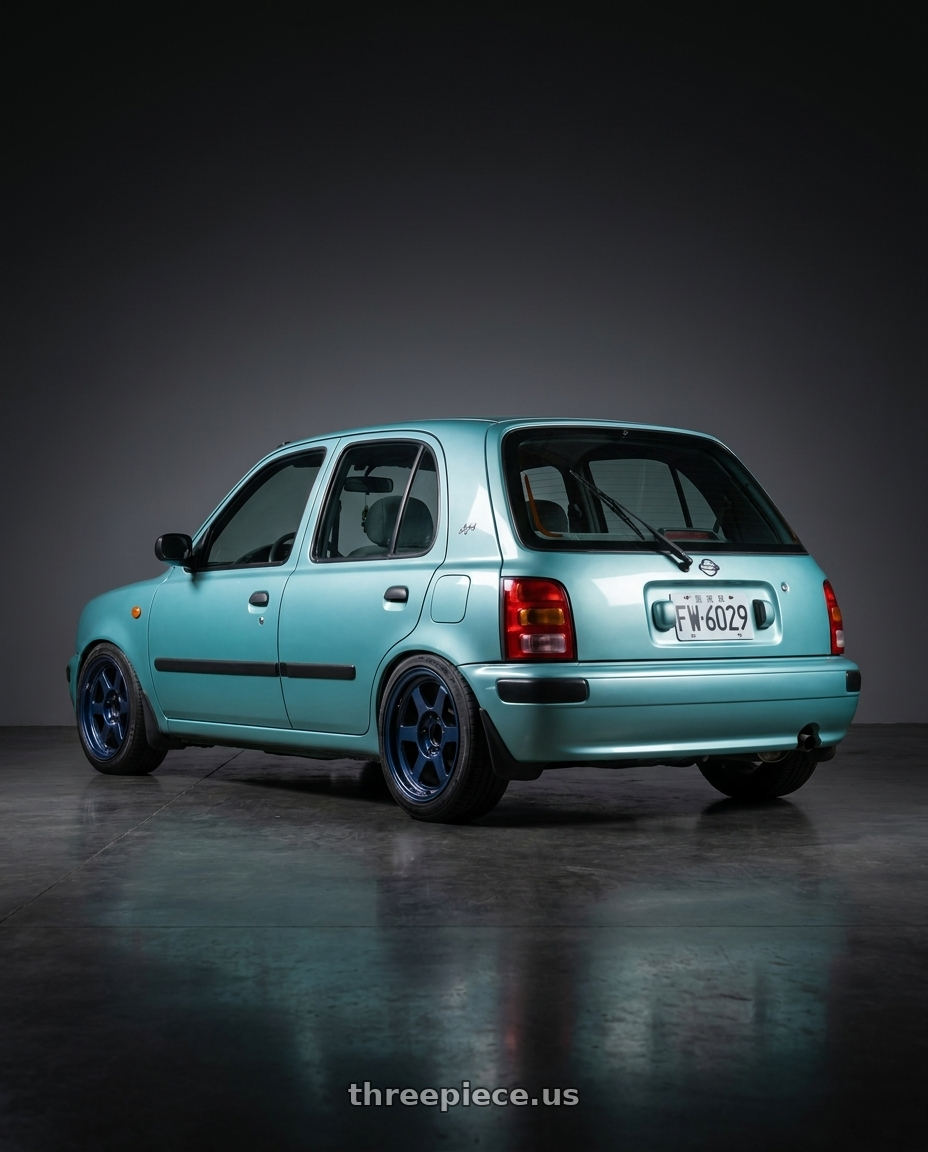 1996 NISSAN MARCH Tiffany Blue with Volk Racing TE37XT M-SPEC 6x139.7 16x8 +0 MAG BLUE wheels rear three quarter view square tires