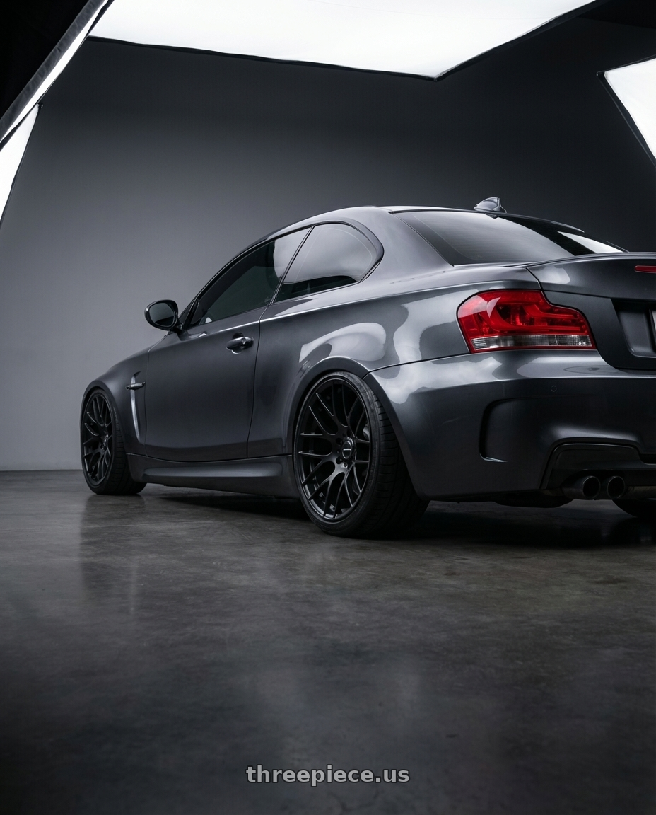 2012 BMW 1 Series E82 with Avant Garde Wheels M359 5X120 19x9 +18 Matte Black wheels rear three quarter view slight stretch tires