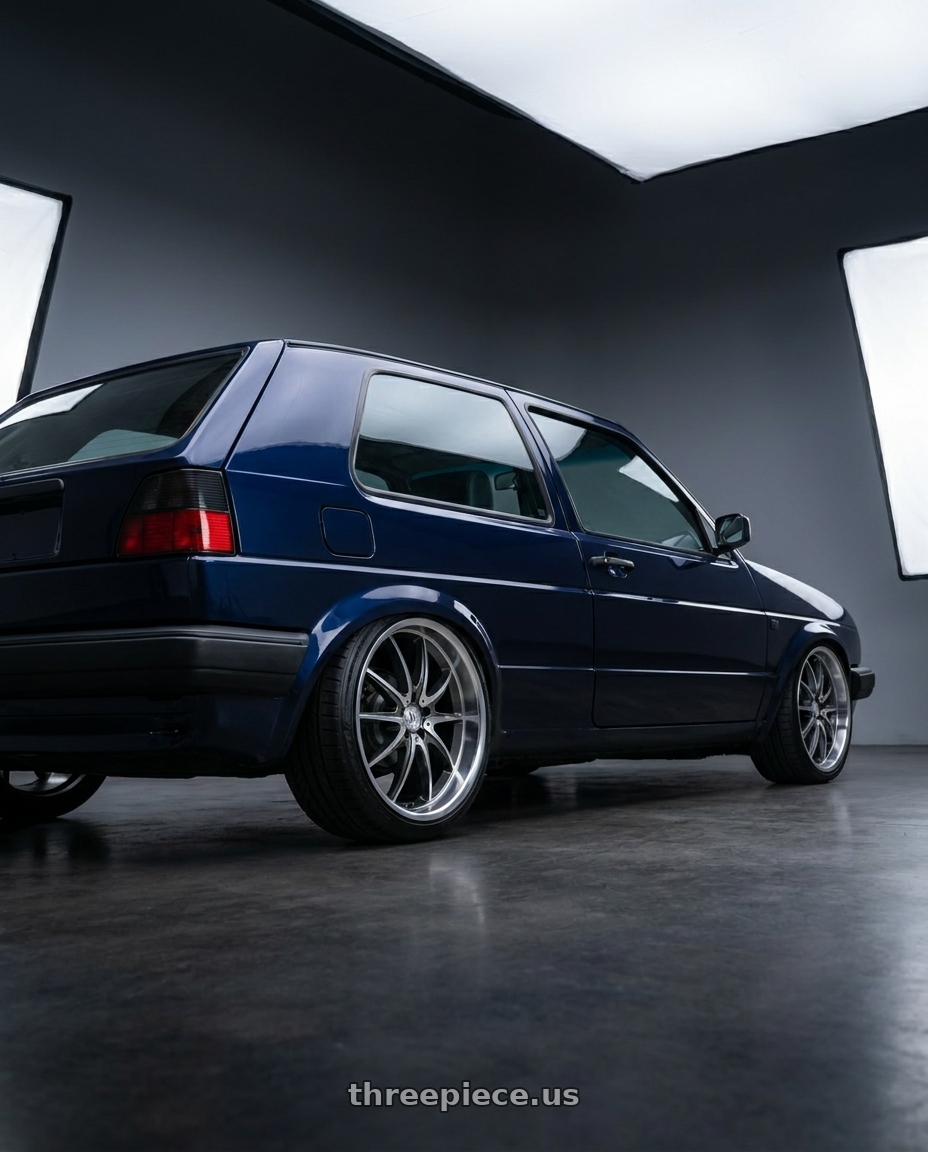 1990 vw golf mk2 hatchback , dark blue with Mandrus ARGENT 5X112 17X8 +42 GLOSS GUNMETAL W/ MIRROR CUT FACE wheels rear three quarter view square tires