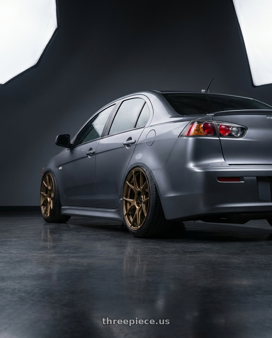 2014 Mitsubishi Lancer Ralliart with Konig Ampliform 5x114.3 18x9.5+25 Gloss Bronze wheels rear three quarter view slight stretch tires