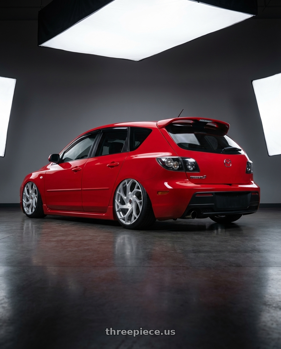 2009 Mazda Mazdaspeed3 Red with Ignite Inferno 5x115/5x120 24x9.5 +15 Silver wheels rear three quarter view slight stretch tires