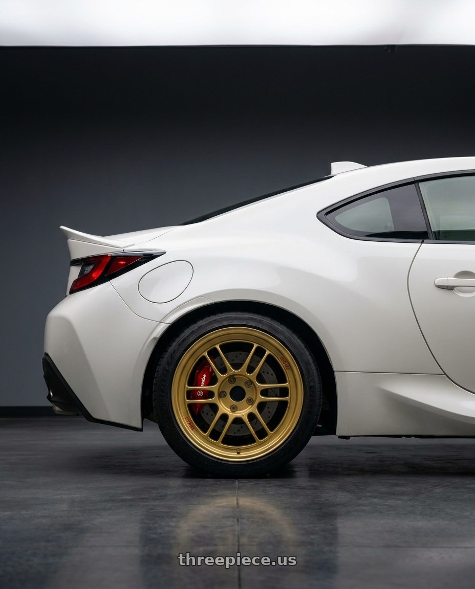 2026 Toyota Gr86 premium red Brembo brakes with Enkei RPF1 5x100 18x8+45 Gold wheels rear three quarter view square tires