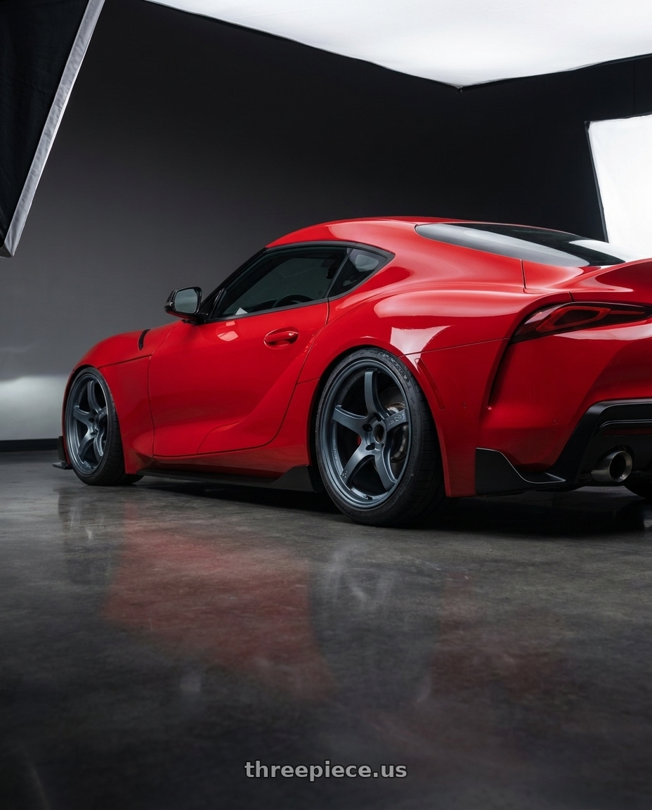 2023 Toyota GR Supra with Gram Lights 57CR 5x112 19x9.5+45 Gunblue II wheels rear three quarter view slight stretch tires