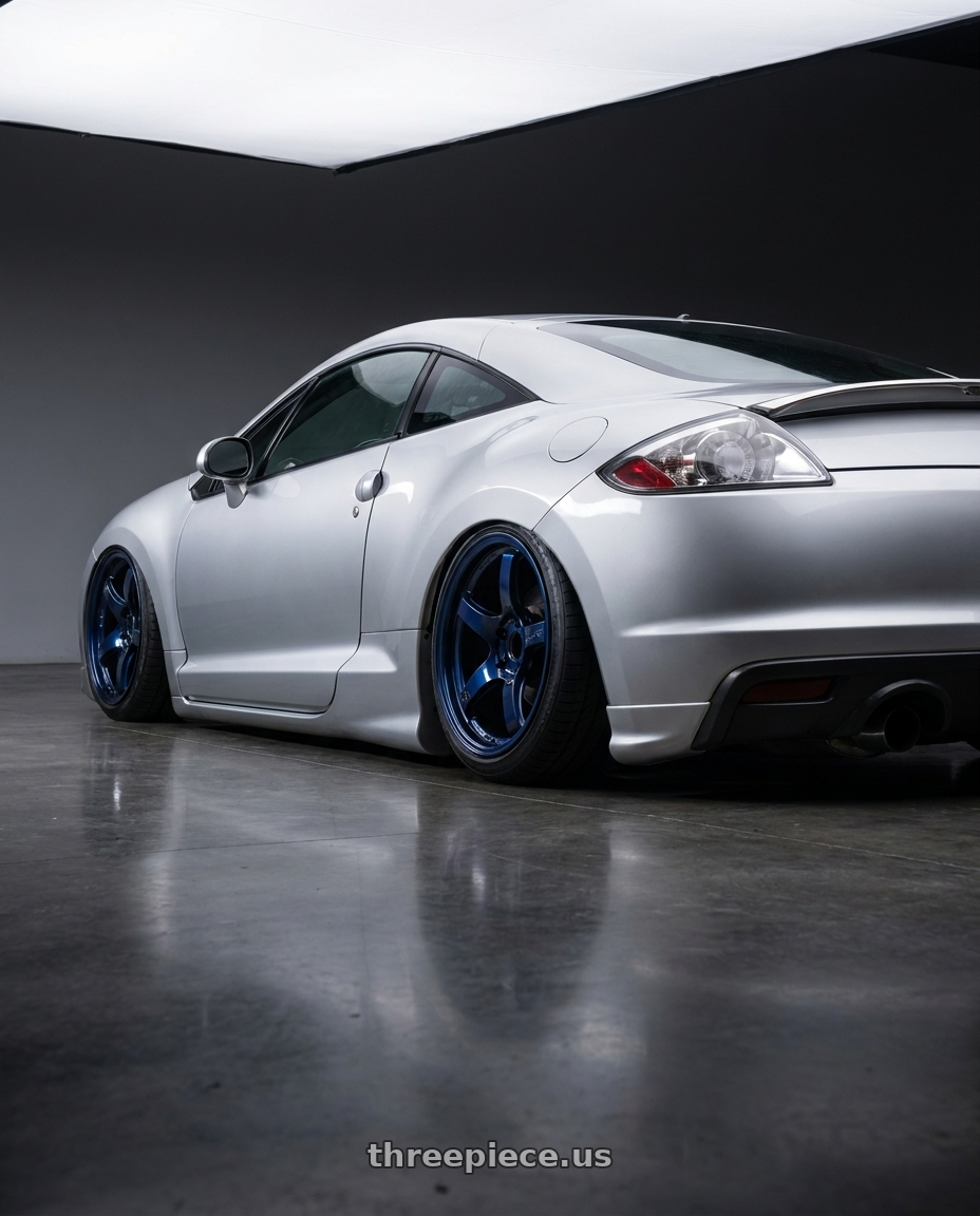 2010 Mitsubishi Eclipse with Gram Lights 57CR 5x114.3 18x9.5+12 Eternal Blue Pearl wheels rear three quarter view slight stretch tires