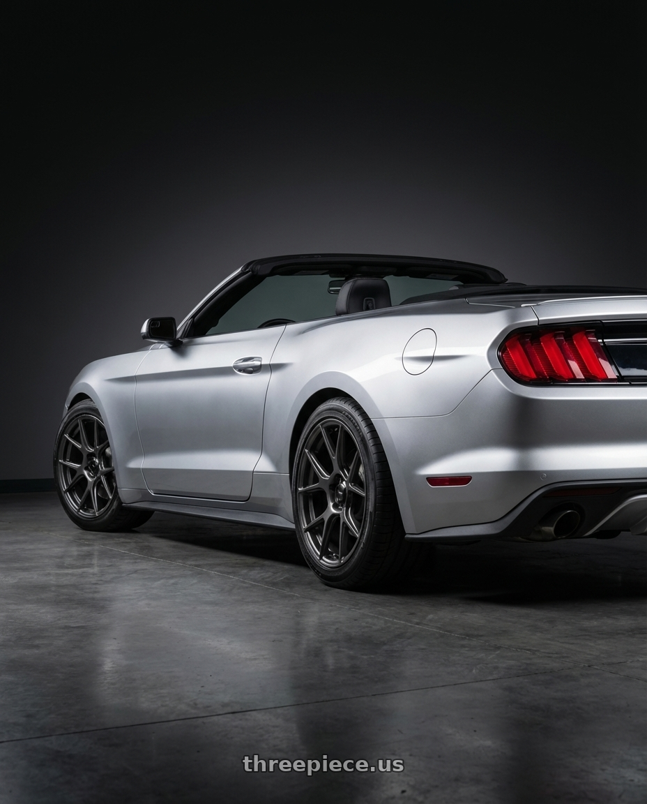 2018 ford mustang with Konig Ampliform 5x114.3 19x10.5+23 Dark Metallic Graphite wheels rear three quarter view slight stretch tires