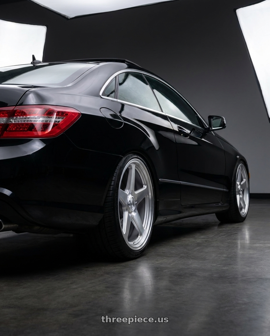 2013 Mercedes-Benz E350 4Matic with DOLCE PERFORMANCE STELLA 5x112 18x8.5 +35 Gloss Silver wheels rear three quarter view square tires