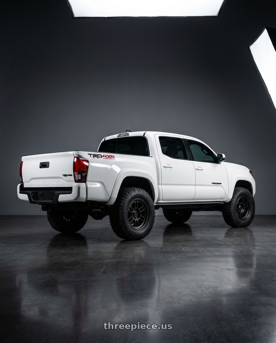 2021 Toyota Tacoma with Enkei RPT1 6x139.7 18x9+0 Black wheels rear three quarter view meaty tires