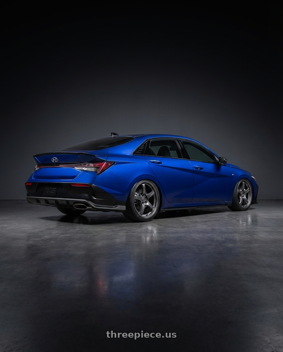 2025 Elantra N Line  with Gram Lights 57CR 5x114.3 18x9.5+38 Glossy Grey wheels rear three quarter view square tires