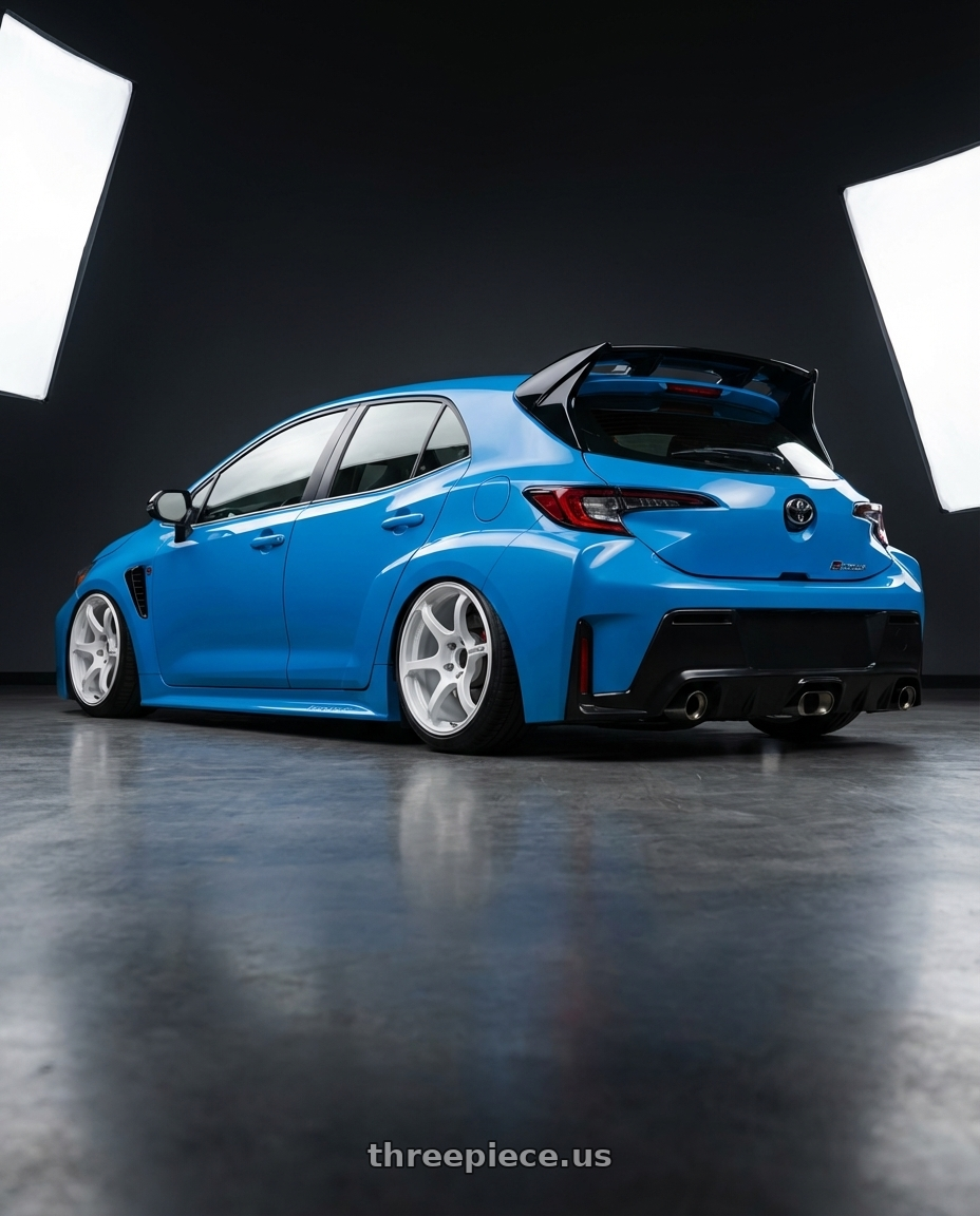 2024 Toyota GR Corolla with Advan Racing RG-4 5x114.3 18x9.5 +35 RACING WHITE METALLIC & RING wheels rear three quarter view slight stretch tires