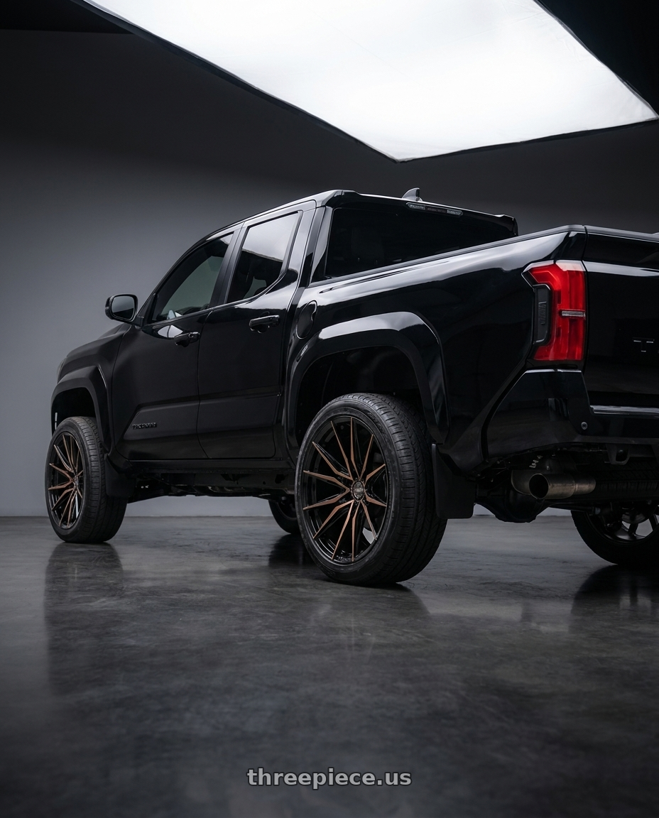 2024 Toyota Tacoma with Arvano ART-3 6x139.7 22x12 -44 Satin Black & Bronze Machined Double Dark Tint wheels rear three quarter view slight stretch tires