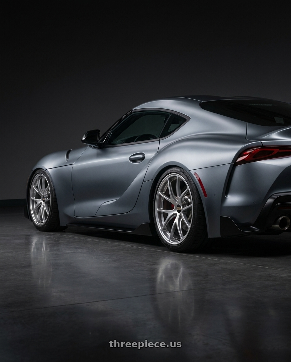 2021 Gr supra 30 premium with BBS RI-A 5x120 18x9.5+23 Diamond Silver wheels rear three quarter view slight stretch tires