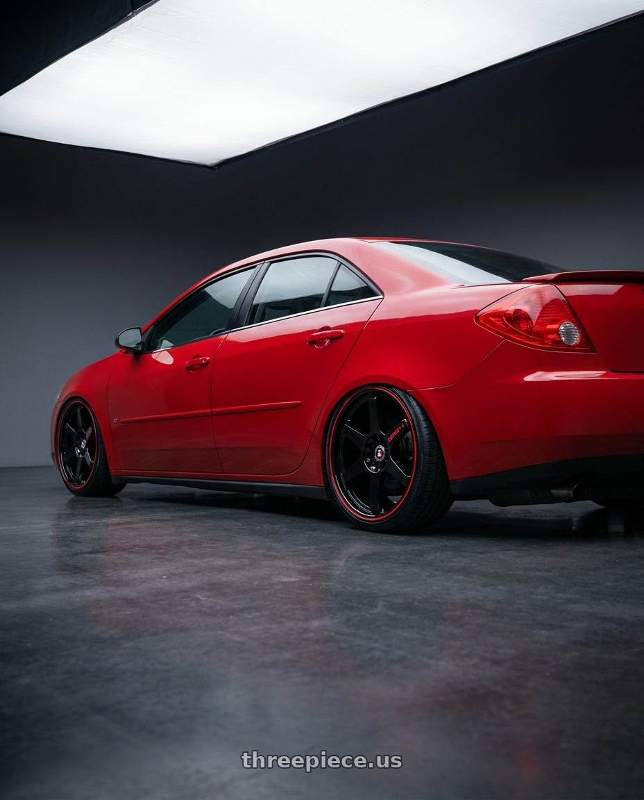 2008 Pontiac G6 GT with Spec-1 SPT-33 5x110/5x114.3 17x8 +38 Gloss Black & Red Line wheels rear three quarter view square tires