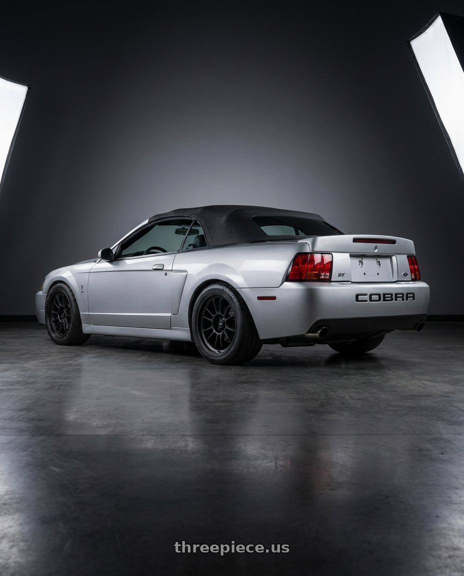 2004 ford mustang  with Konig Hypergram 5x114.3 18x9.5+25 Matte Black wheels rear three quarter view square tires