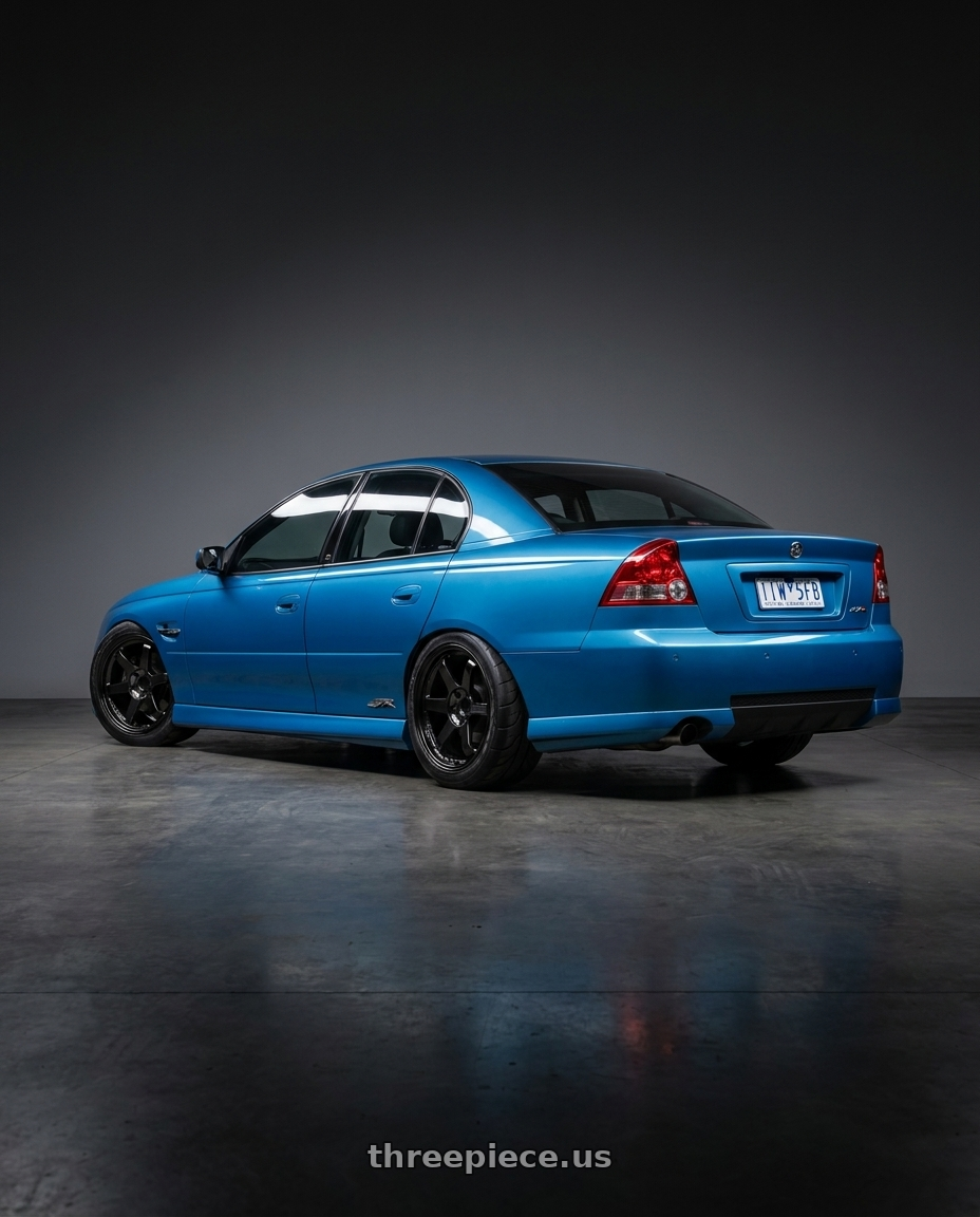 2006 Holden commodore with Volk Racing TE37SL 5x114.3 19x10.5+12 Pressed Double Black wheels rear three quarter view meaty tires