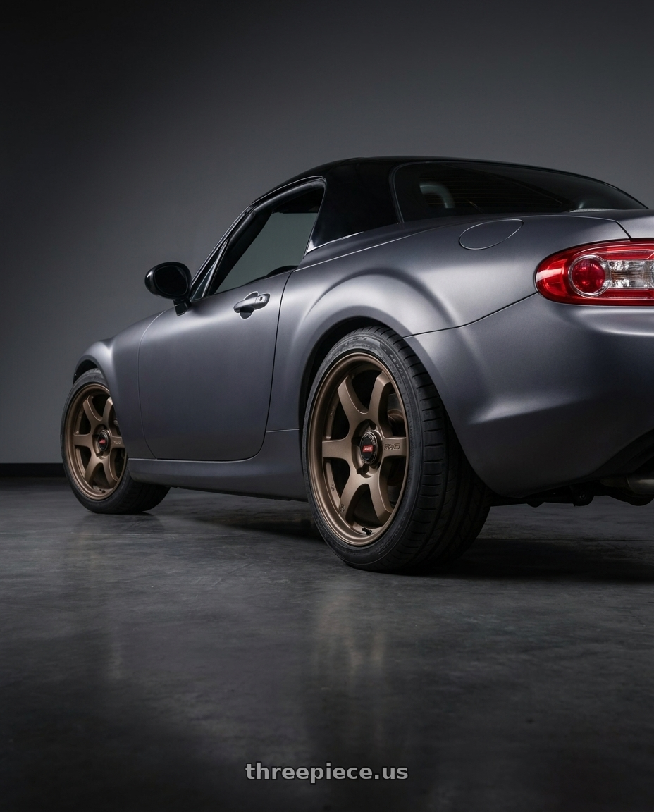 2007 Mazda Miata MX-5 with Gram Lights 57DR-X2 5x114.3 16x7+40 Dark Bronze wheels rear three quarter view square tires