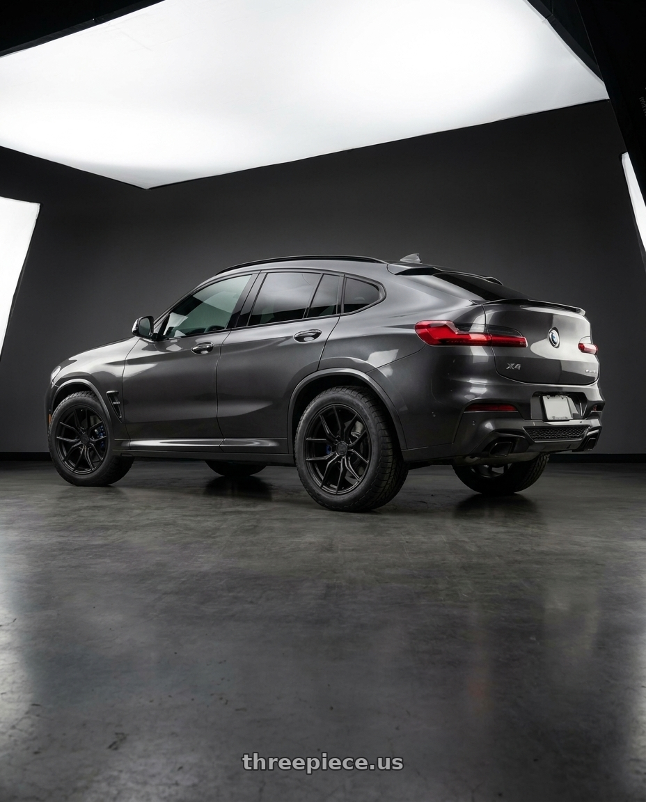 2023 BMW X4 with Aodhan AFF2 5x112 20x9+30 Matte Black wheels rear three quarter view meaty tires