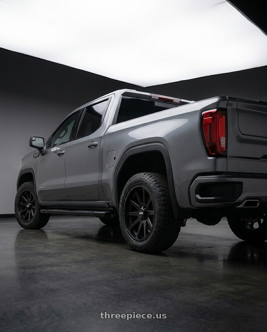 2021 GMC Sierra 1500 AT4 with Ion Type 143 6x139.7 20x9+18 Matte Black wheels rear three quarter view square tires