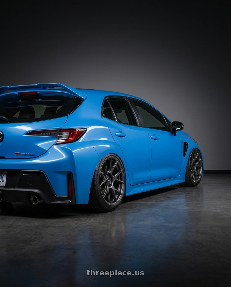 2024 Toyota GR Corolla with Konig Ampliform 5x114.3 18x8.5+35 Dark Metallic Graphite wheels rear three quarter view slight stretch tires