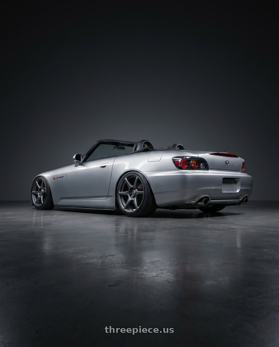 2009 Honda S2000 with Kansei K11G Tandem 5x114.3 18x9 12 Gunmetal wheels rear three quarter view slight stretch tires