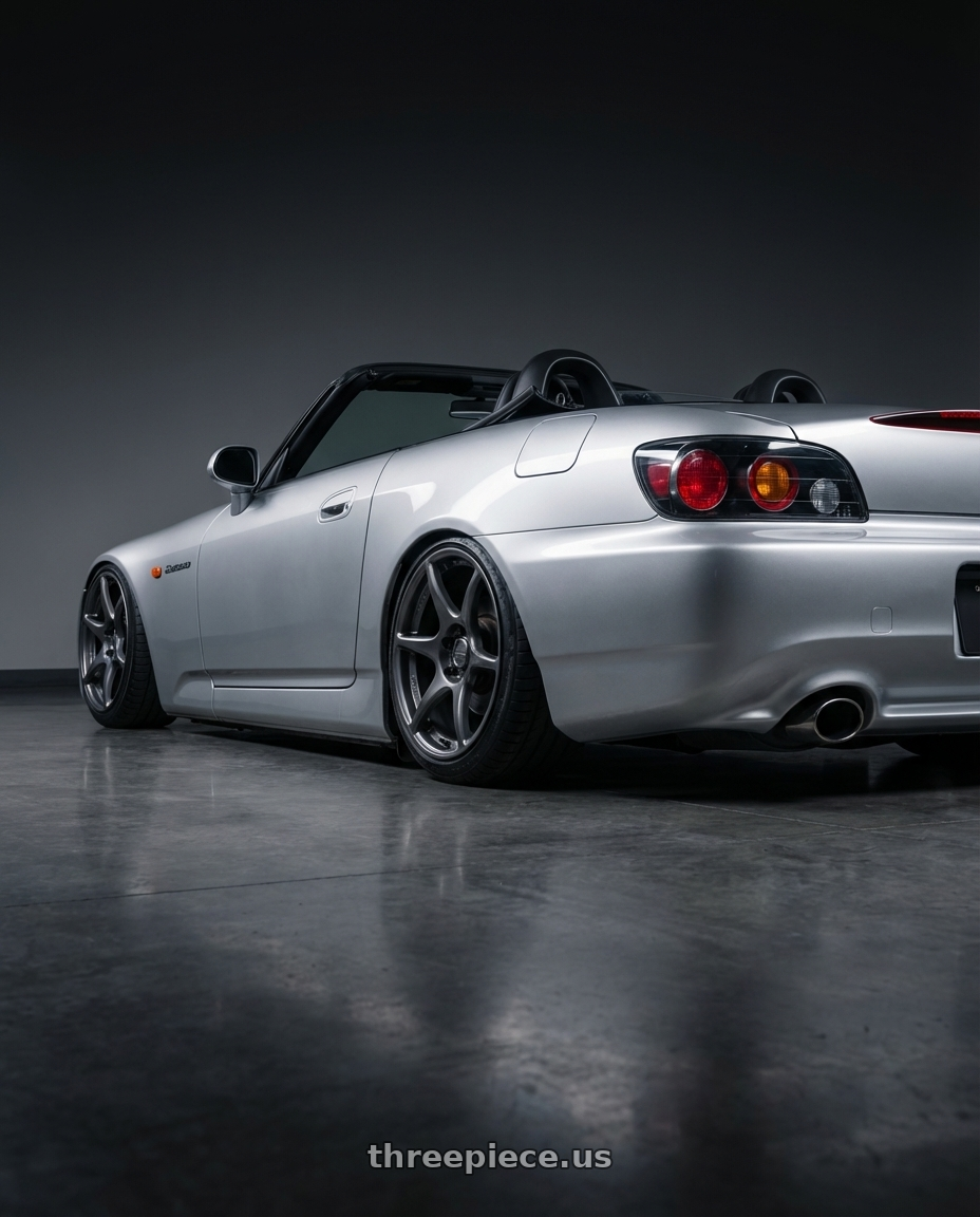 2009 Honda S2000 with Kansei K11G Tandem 5x114.3 18x8.5 35 Gunmetal wheels rear three quarter view slight stretch tires