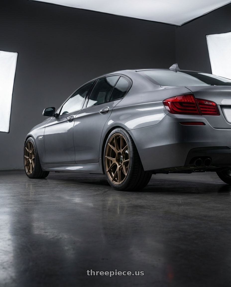2016 BMW 5 Series F10 with Konig Ampliform 5x120 19x8.5+32 Gloss Bronze wheels rear three quarter view square tires
