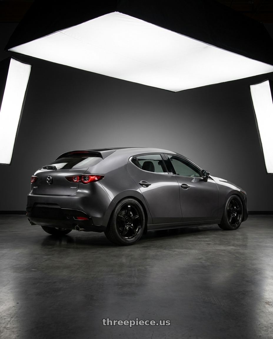 2020 Mazda 3 Hb with Gram Lights 57CR 5x100 18x9.5+38 Glossy Black wheels rear three quarter view square tires