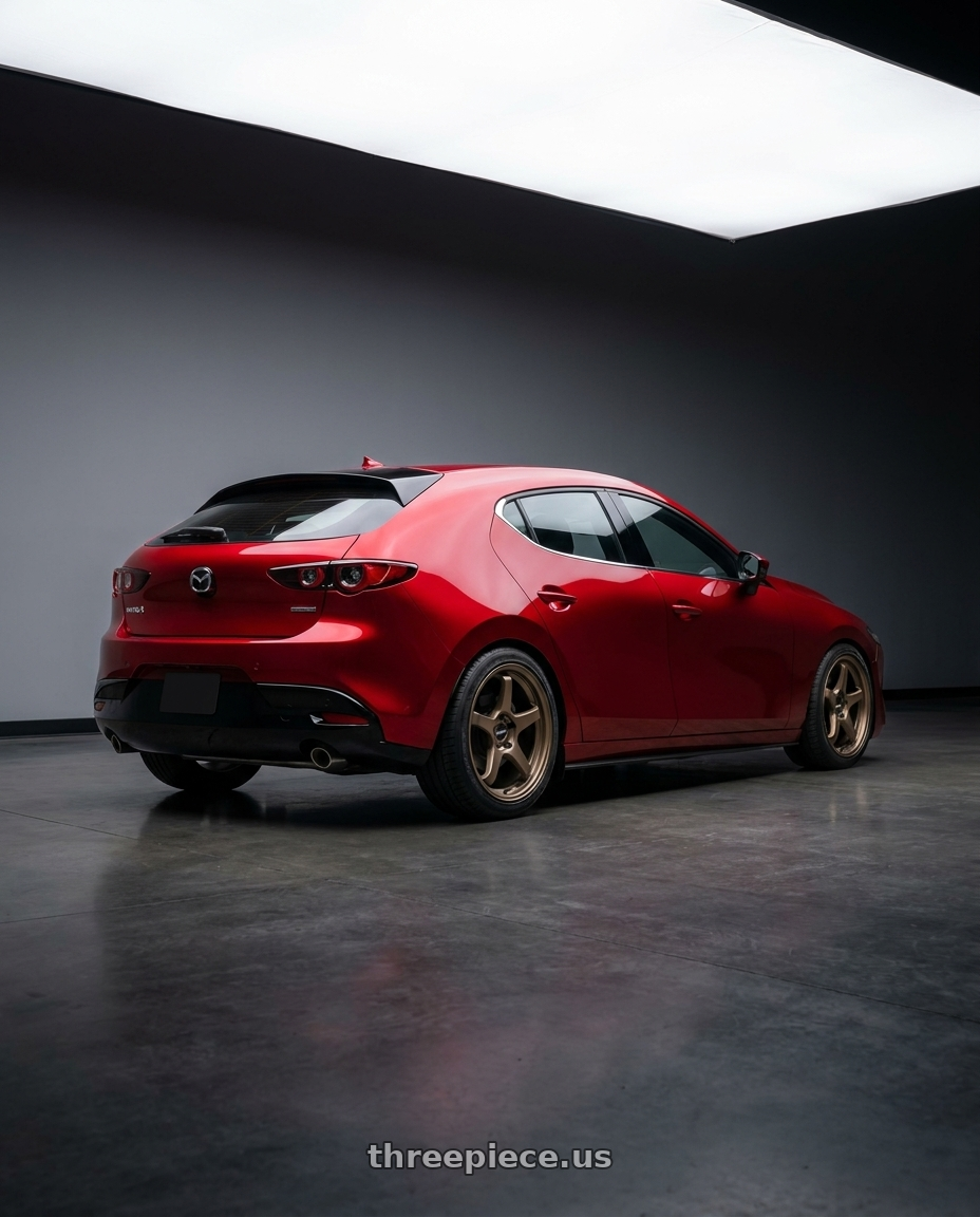 2026 Mazda 3 hatchback soul red with Enkei TS-5 5x114.3 18x8.5+38 Bronze wheels rear three quarter view square tires