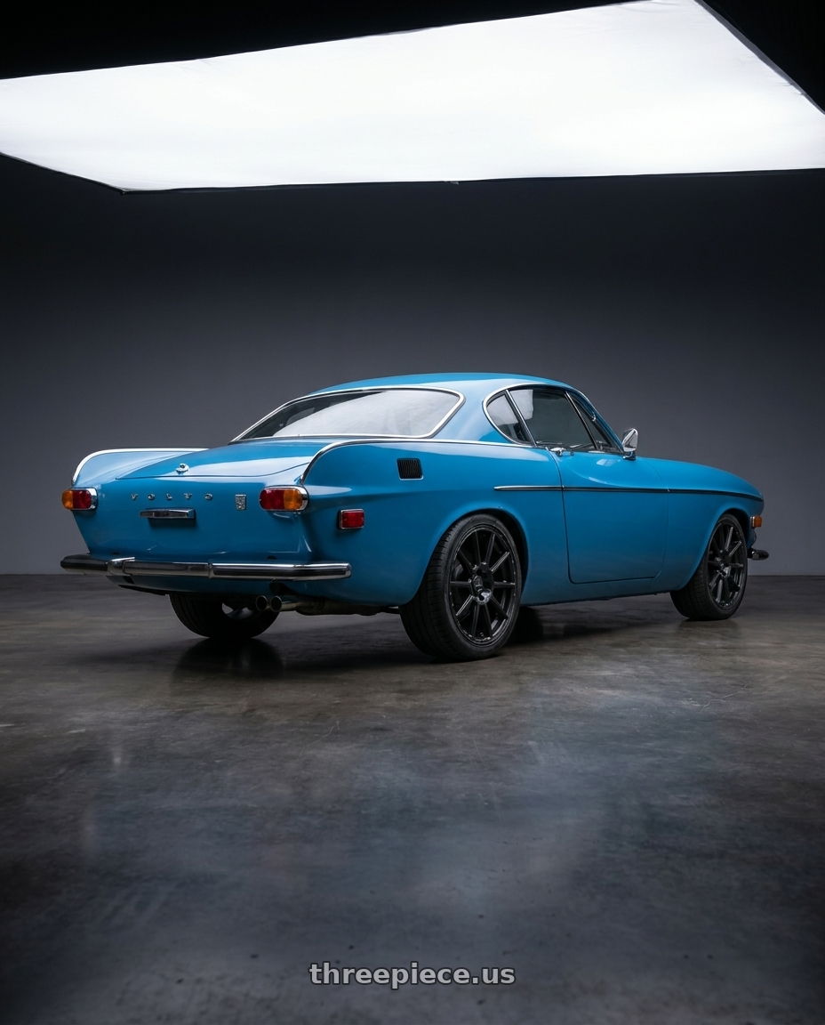 1972 Volvo 180E with V�xx Monte 5x108/5x114.3 18x8+40 Matte Black wheels rear three quarter view square tires