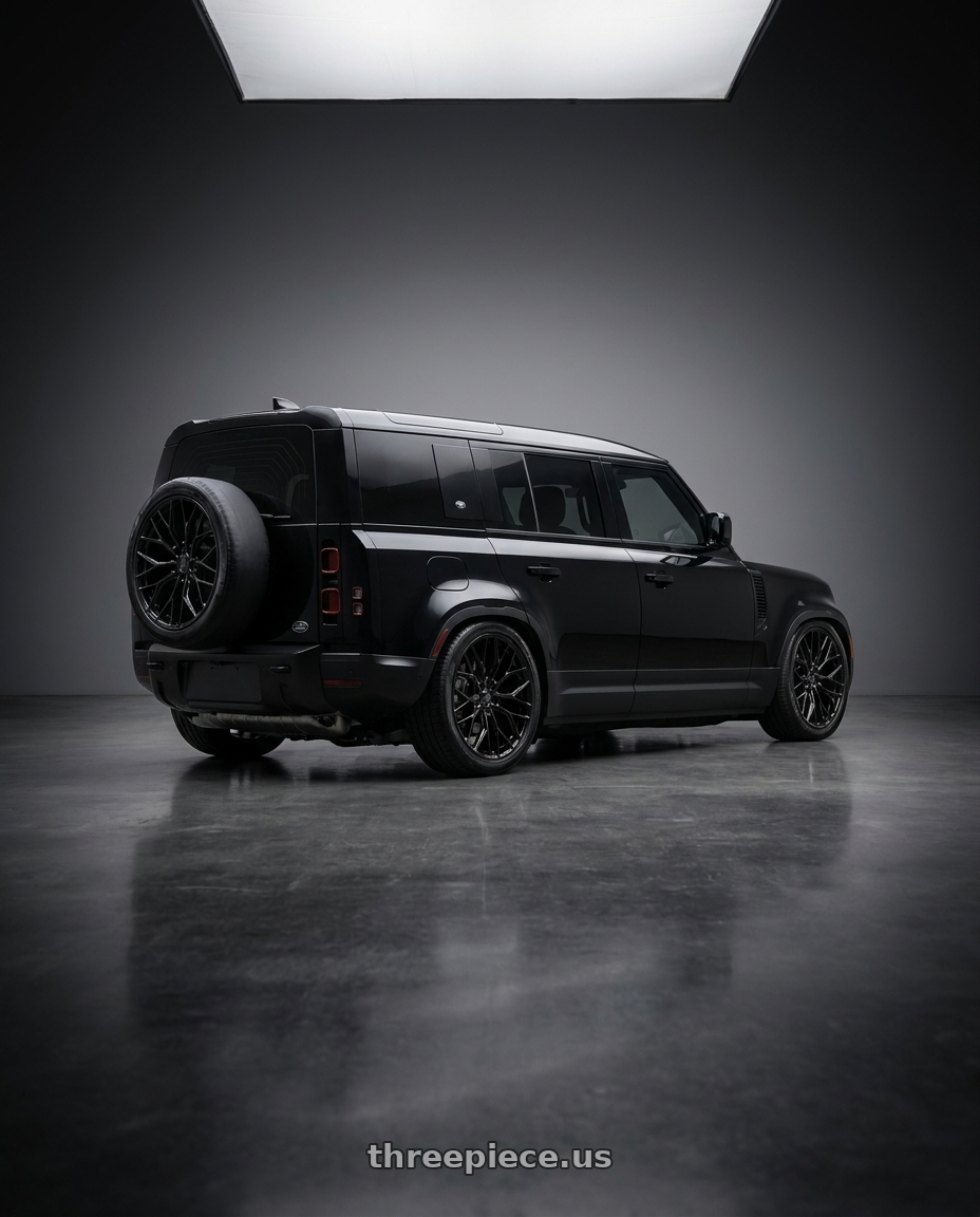 2025 Land Rover Defender 110 with DOLCE PERFORMANCE MAGARI 5x120 22x10.5 +40 Gloss Black wheels rear three quarter view square tires