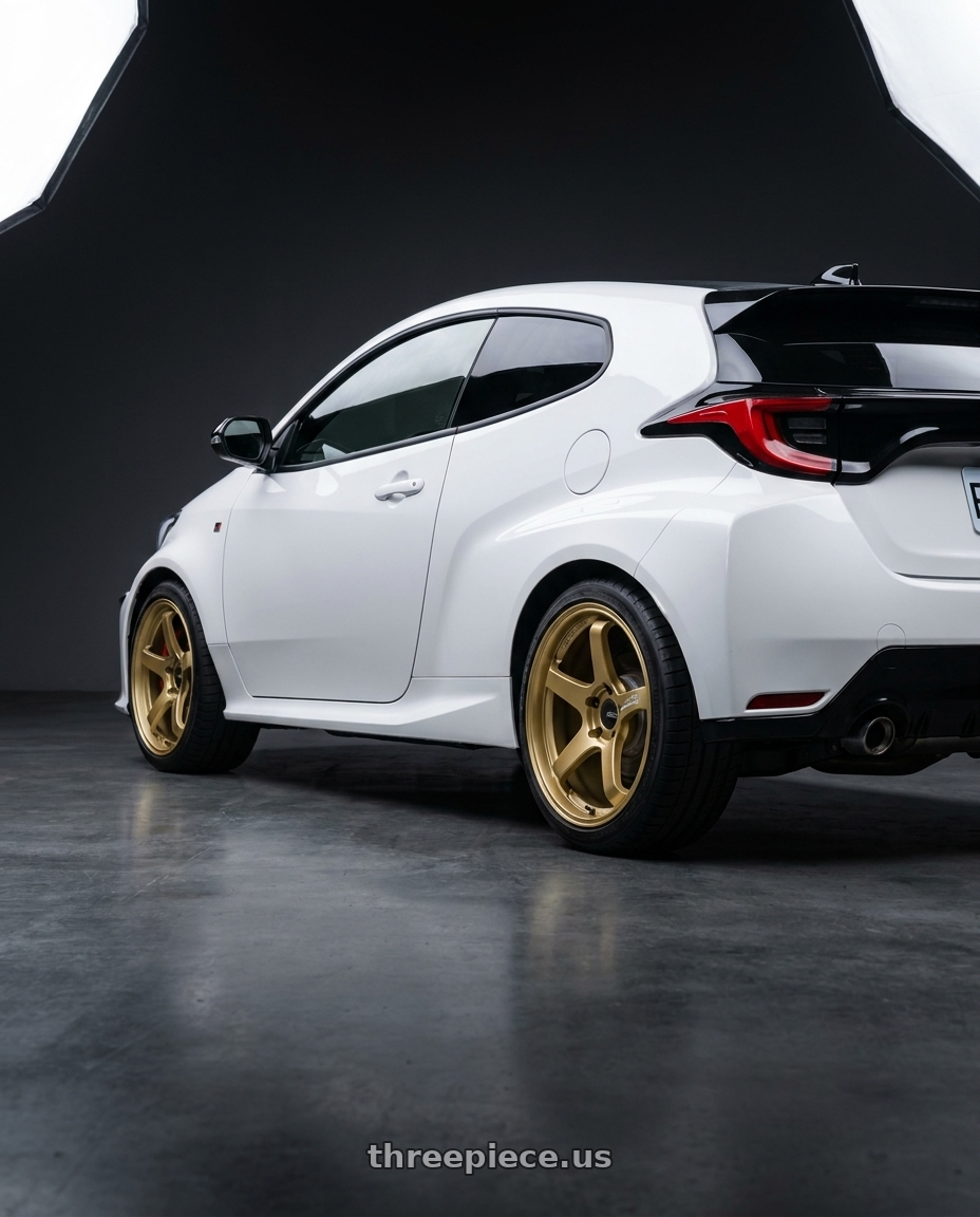 2021 gr yaris with Advan Racing GT for PORSCHE 5x130 18x8.5 +50 RACING GOLD METALLIC wheels rear three quarter view square tires