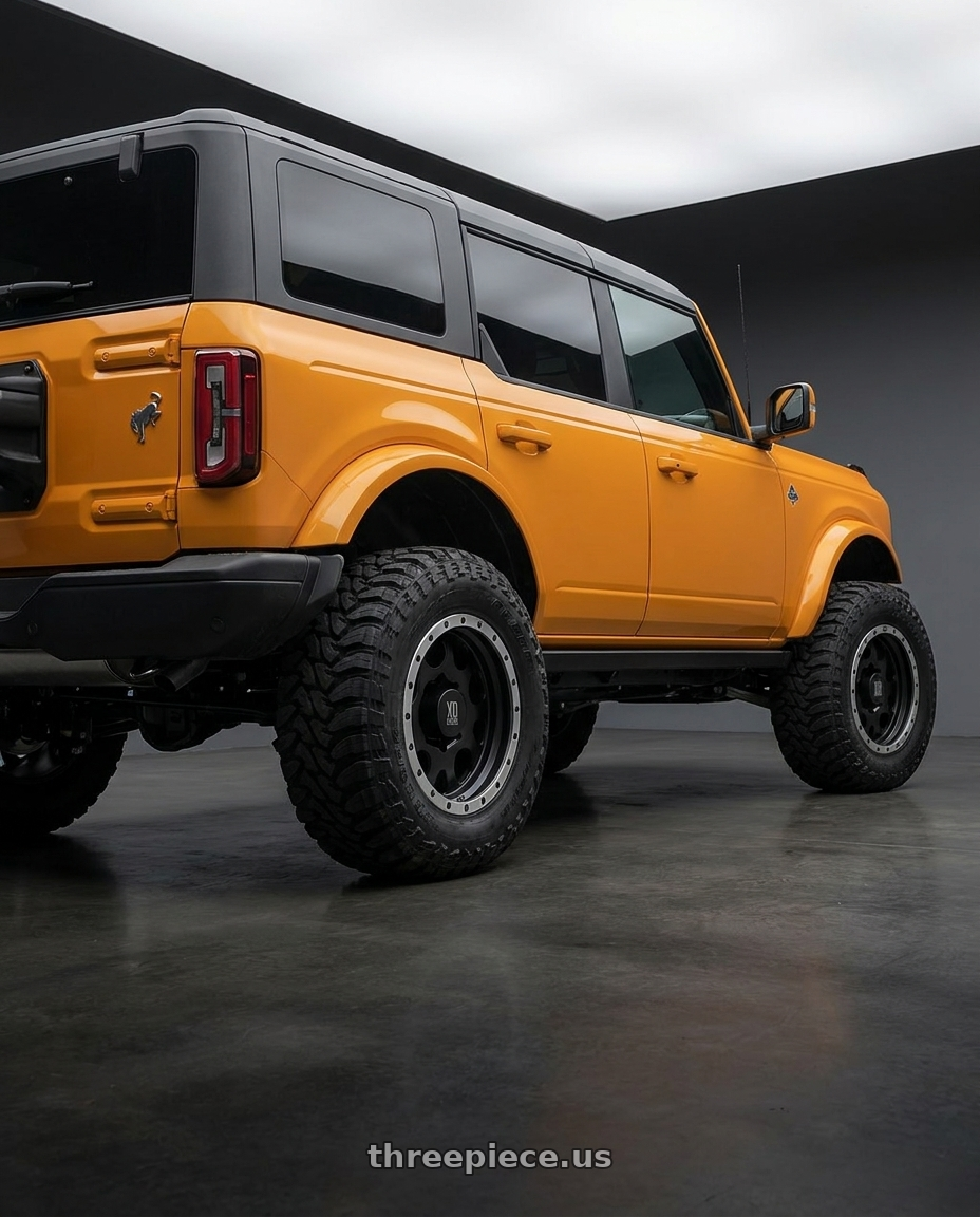 2024 Ford Bronco with XD XD125 6X139.7 20X9 +18 MATTE BLACK WITH MACHINED REINFORCING RING wheels rear three quarter view meaty tires
