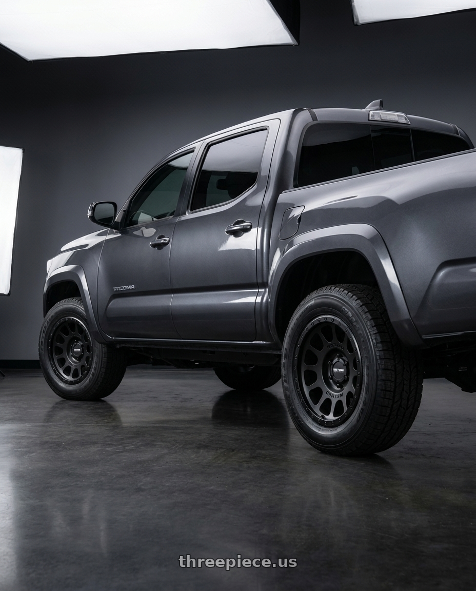 2020 toyota tacoma with Method MR305 NV 17x8.5 0mm Offset 5x150 116.5mm CB Matte-Gloss Black Wheel - MR305785581000 wheels rear three quarter view slight stretch tires