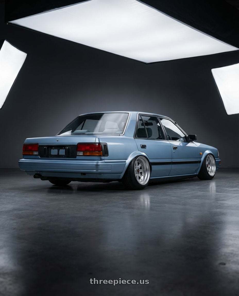 Nissan bluebird 1987 with Speed Star Mk-III 4x100 15X9+0  Silver wheels rear three quarter view extreme stretch tires