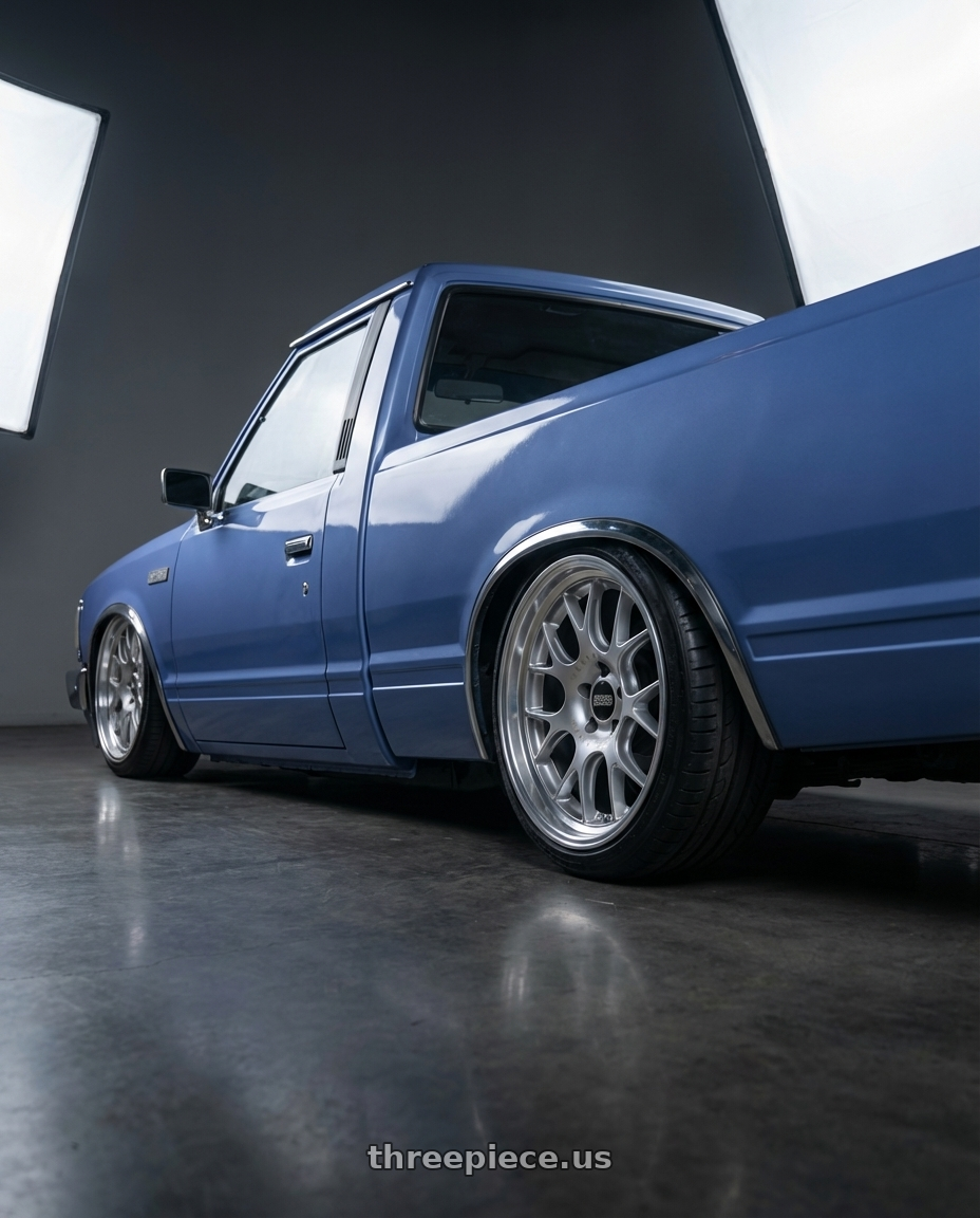 1985 nissan 720 with BBS CH-R 5x130 20x11.5 +47 Brilliant Silver Polished Rim Protector wheels rear three quarter view slight stretch tires