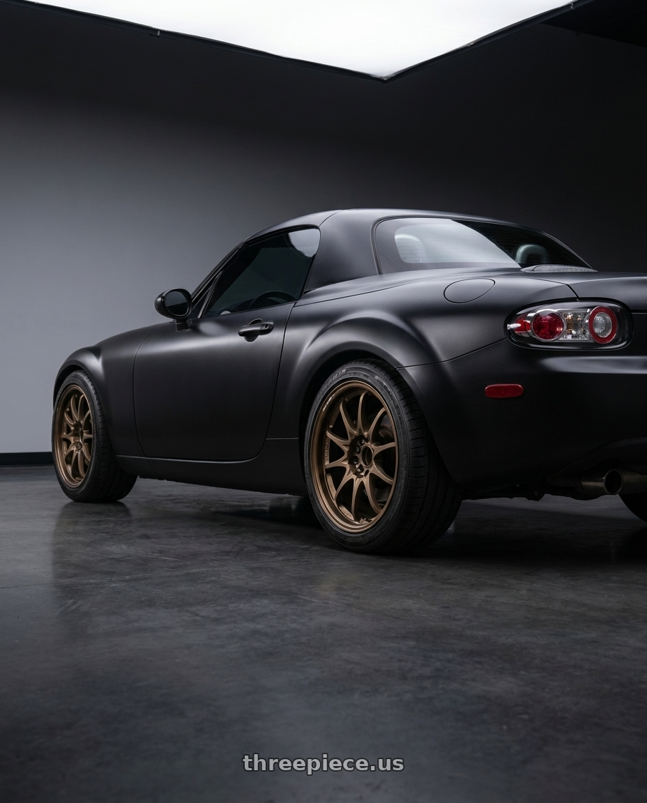2007 Mazda Miata MX-5 with Volk Racing CE28N-PLUS M-SPEC 5x114.3 17x7.5+44 Bronze wheels rear three quarter view square tires