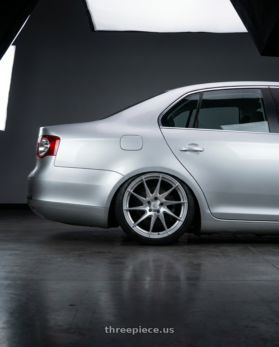 2009 Volkswagen Jetta GLI MK5 with Aodhan AH09 5x112 18x9.5 +35 Gloss Silver Machined Face wheels rear three quarter view slight stretch tires