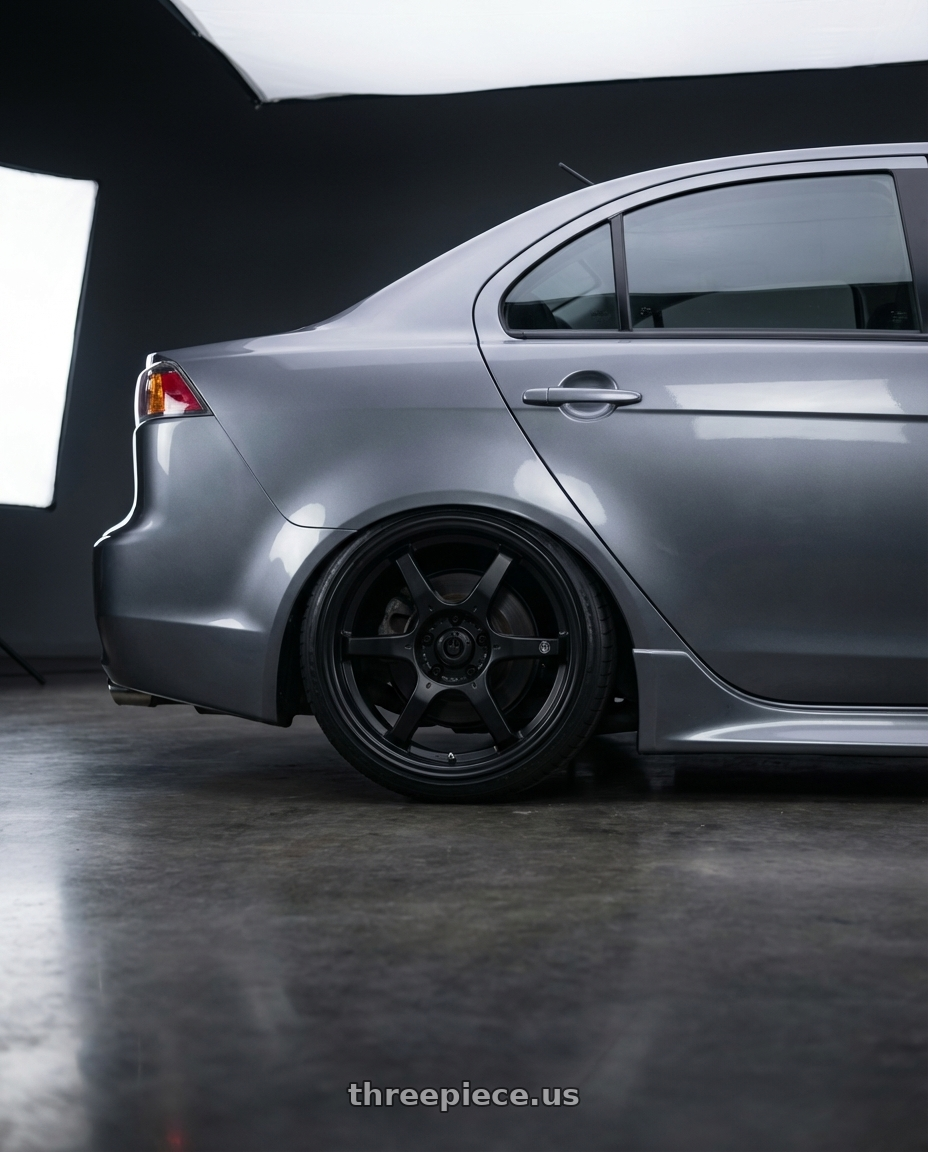 2014 Mitsubishi Lancer Ralliart with Konig Backbone 5x114.3 18x8+35 Matte Black Milling Logo on Spoke wheels rear three quarter view slight stretch tires