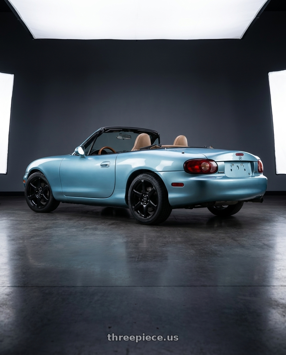 2002 Mazda Miata with Raceline 146B Matrix 4X100/4x114.3 14x5.5 35 Gloss Black wheels rear three quarter view square tires
