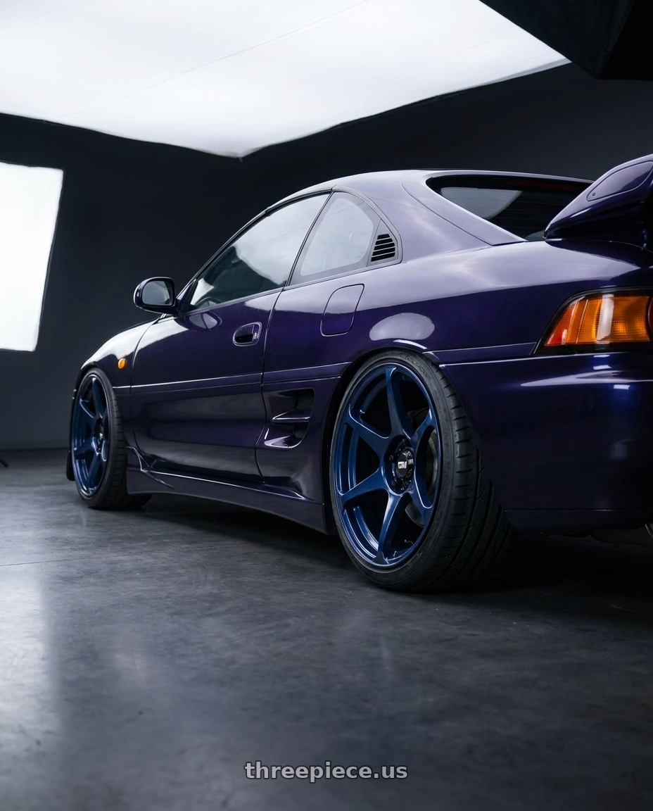 1998 Toyota MR2 with Motegi MR154 BATTLE 5X114.3 17X9.5 +30 MIDNIGHT BLUE wheels rear three quarter view extreme stretch tires
