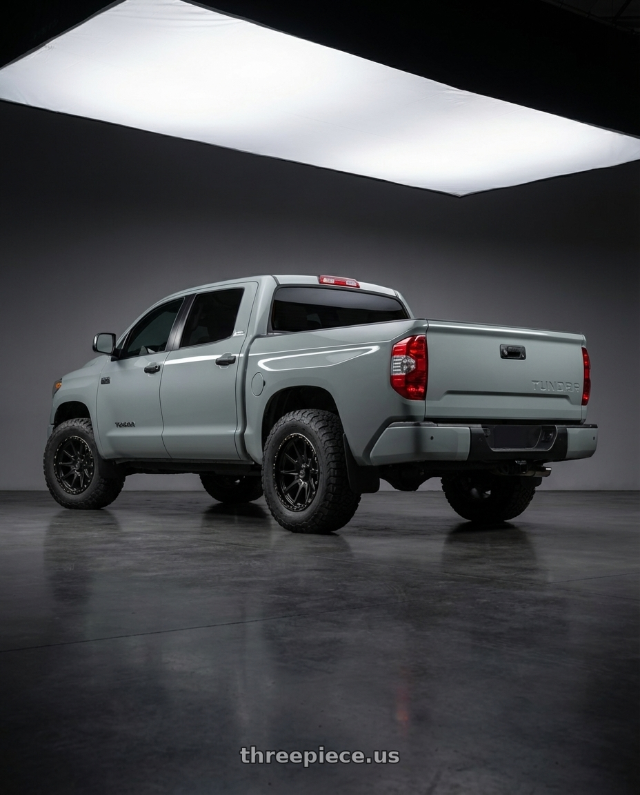 2018 Toyota Tundra with KMC KM100 SYNC 5X150 20X9 +18 SATIN BLACK wheels rear three quarter view meaty tires