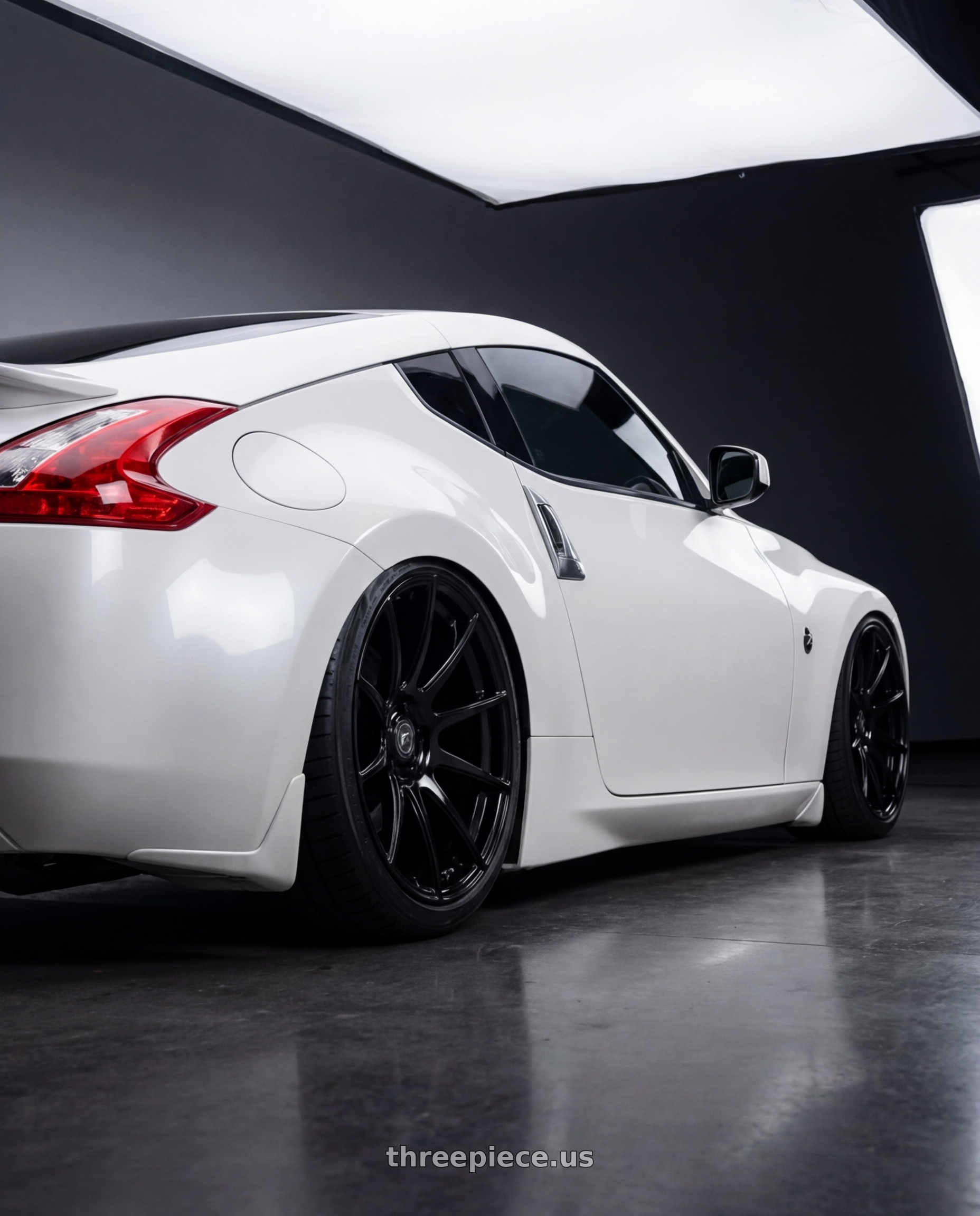 2019 Nissan 370Z with Forgestar CF10 5x114.3 19x9 +35 Gloss Black wheels rear three quarter view slight stretch tires