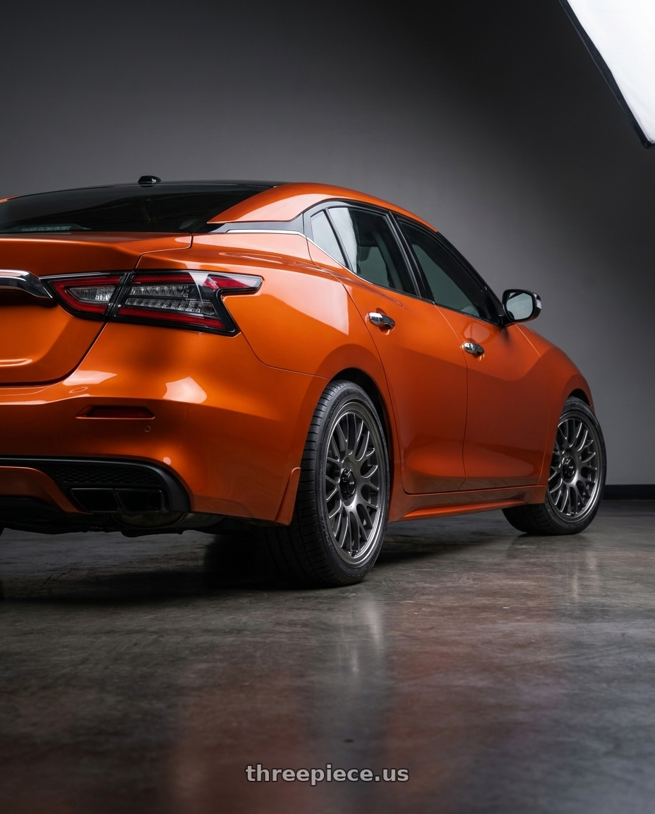 2021 Nissan Maxima Orange with Konig MRK1 5X114.3 19x9.5+40 Hyper Carbon - Gloss Black Gear Cap/Logo/Cover Plate wheels rear three quarter view square tires
