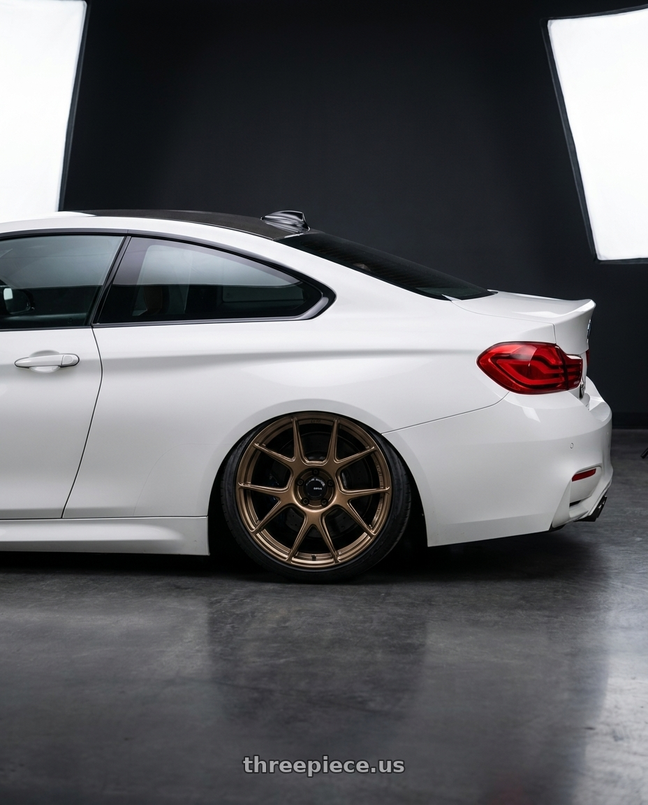 2018 BMW M4 F82 with Konig Ampliform 5x120 19x8.5+32 Gloss Bronze wheels rear three quarter view slight stretch tires